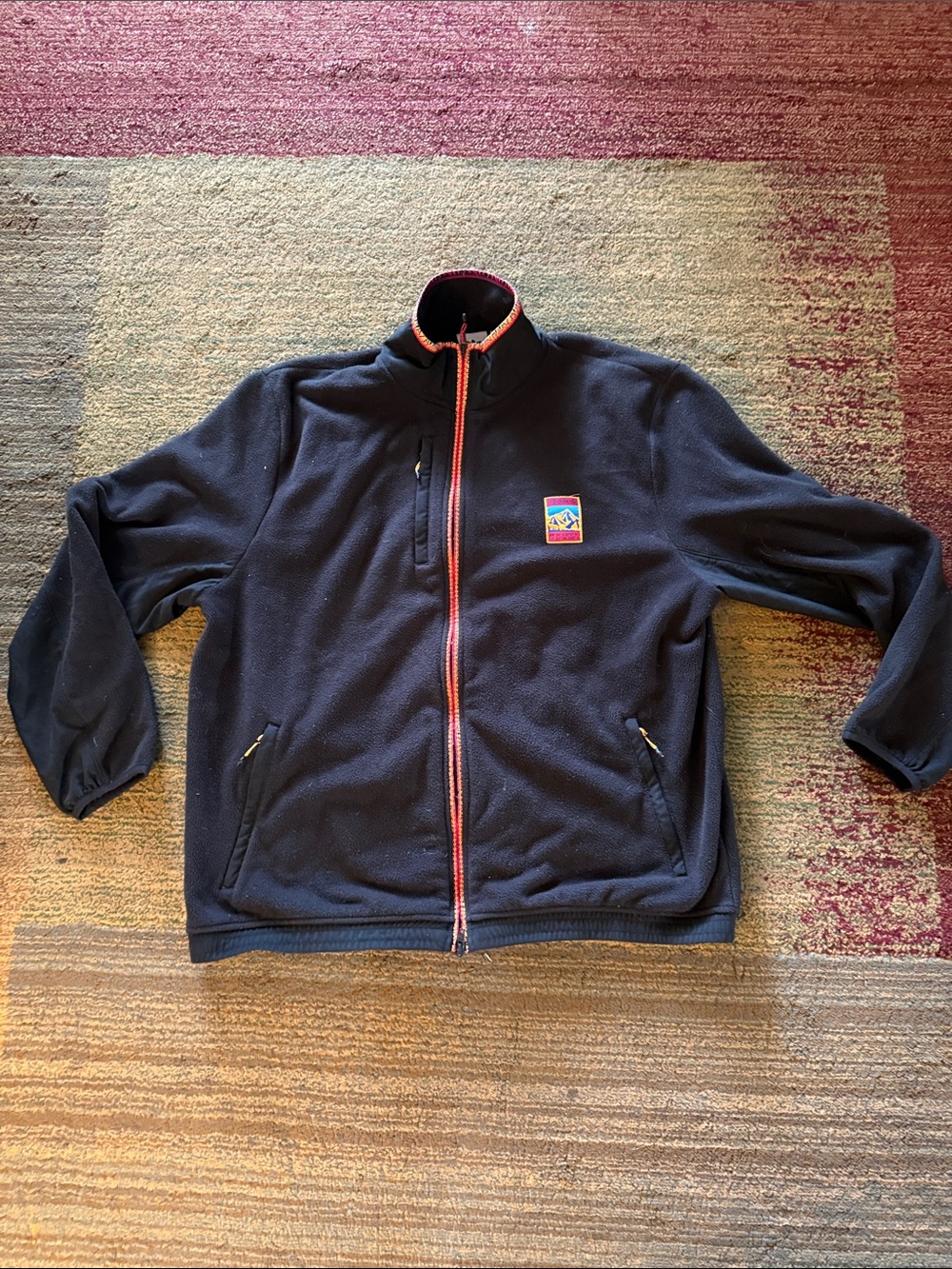 adidas black fleece jacket with red and yellow zipper details and special patch